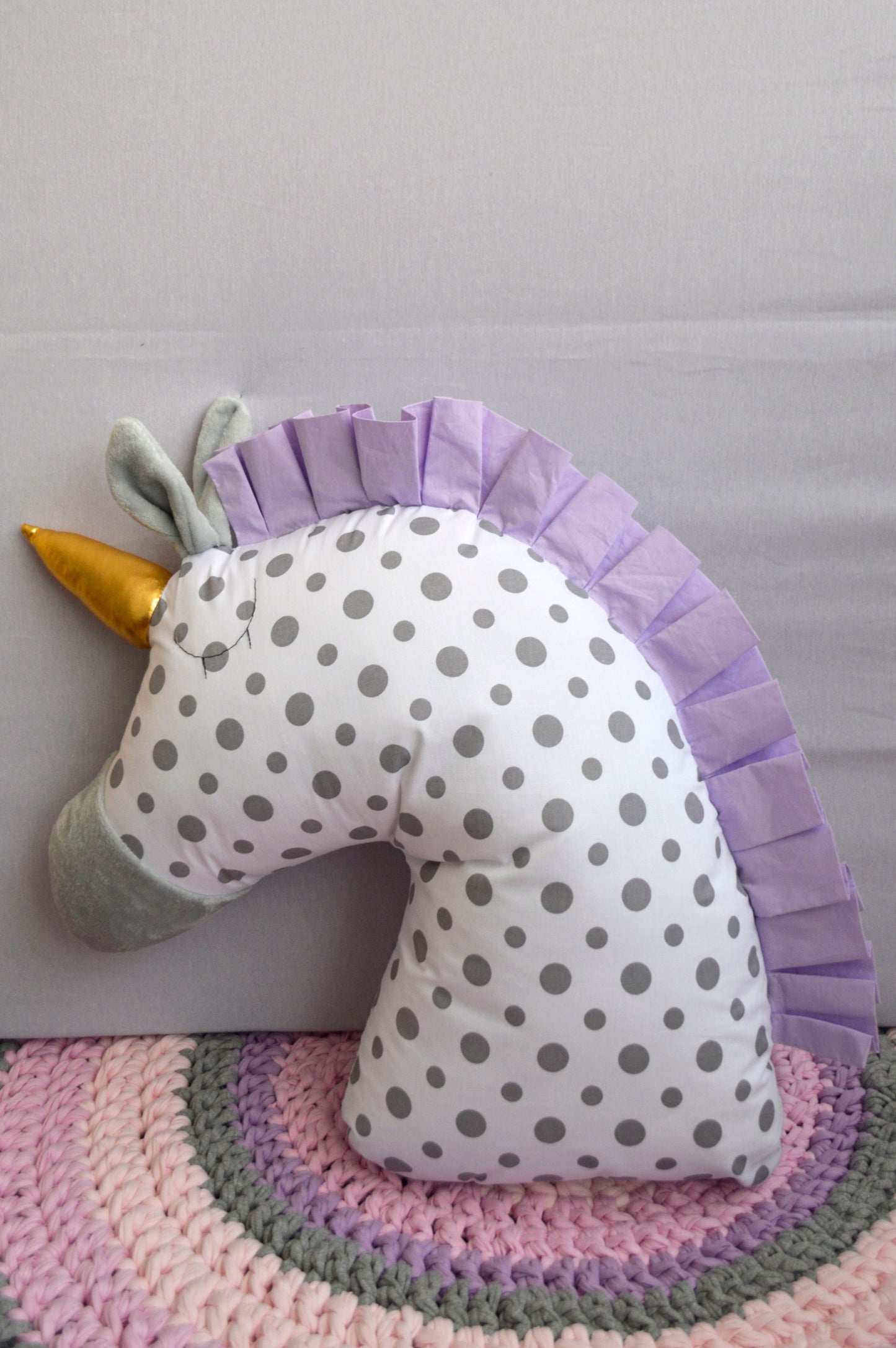 Cojín unicornio morado.